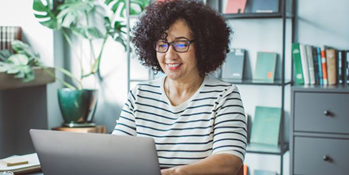Woman on laptop learning about retirement